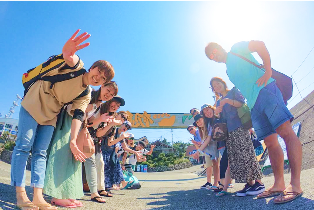 お店の前で列に並んで笑う男女